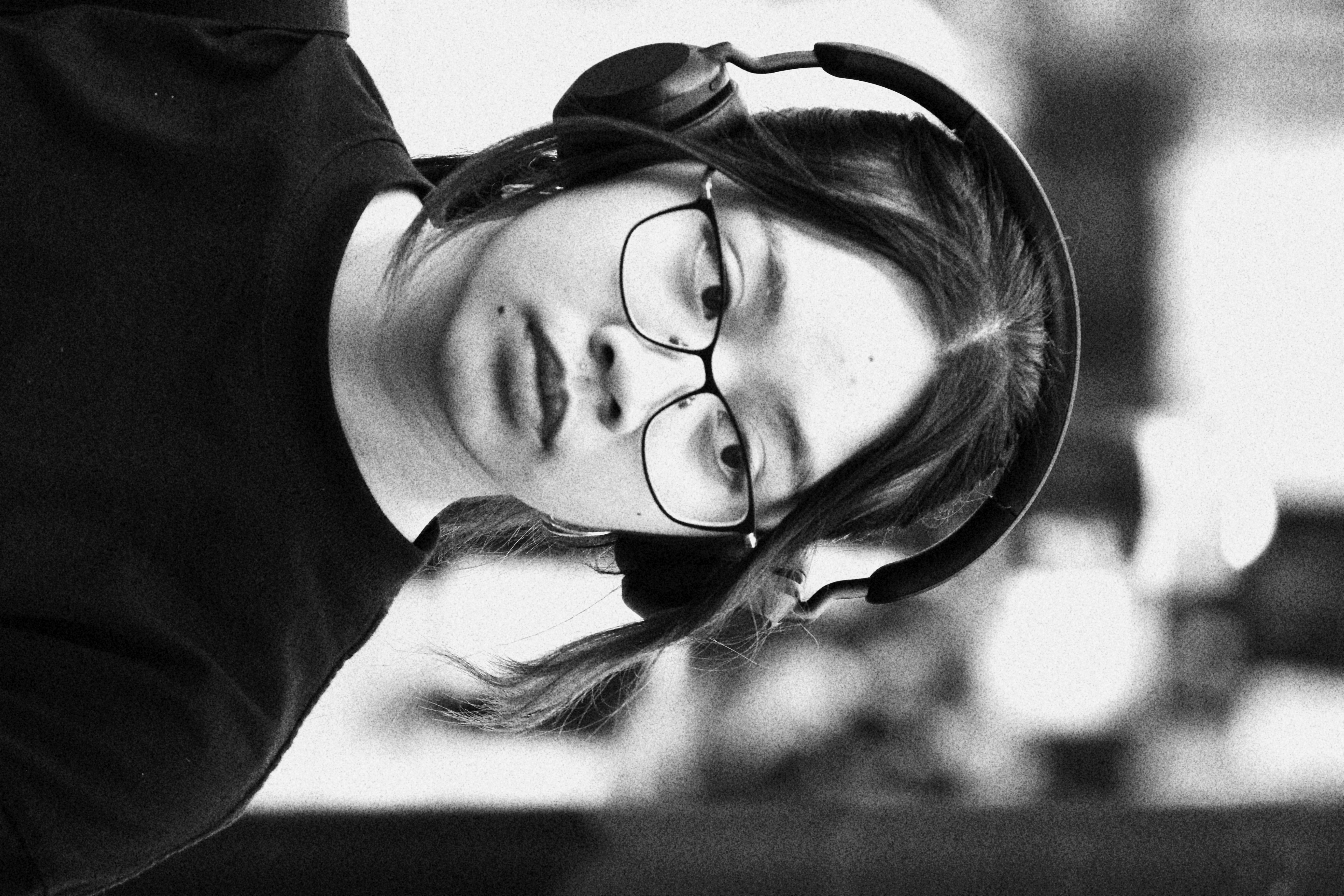 Portrait taken by Chicago based photographer Anthony Z. Royster in London, United Kingdom. Photography is of  young woman in the traffic of Camden town watching for traffic, aware of her surrounding but also present in her music. 